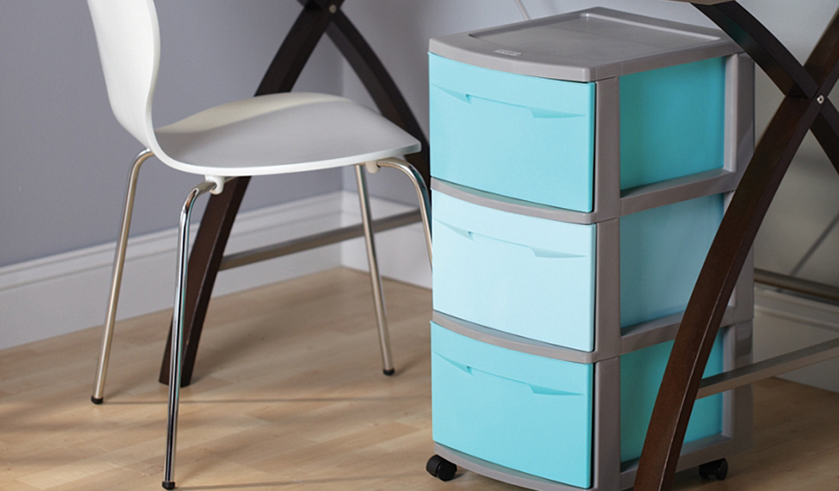 plastic storage container tower under a desk