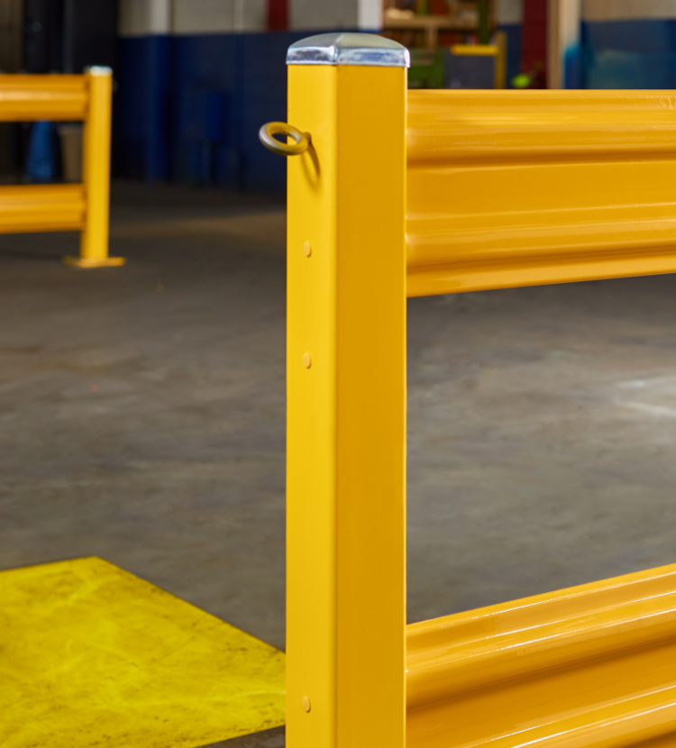 factory floor with safety barriers painted yellow