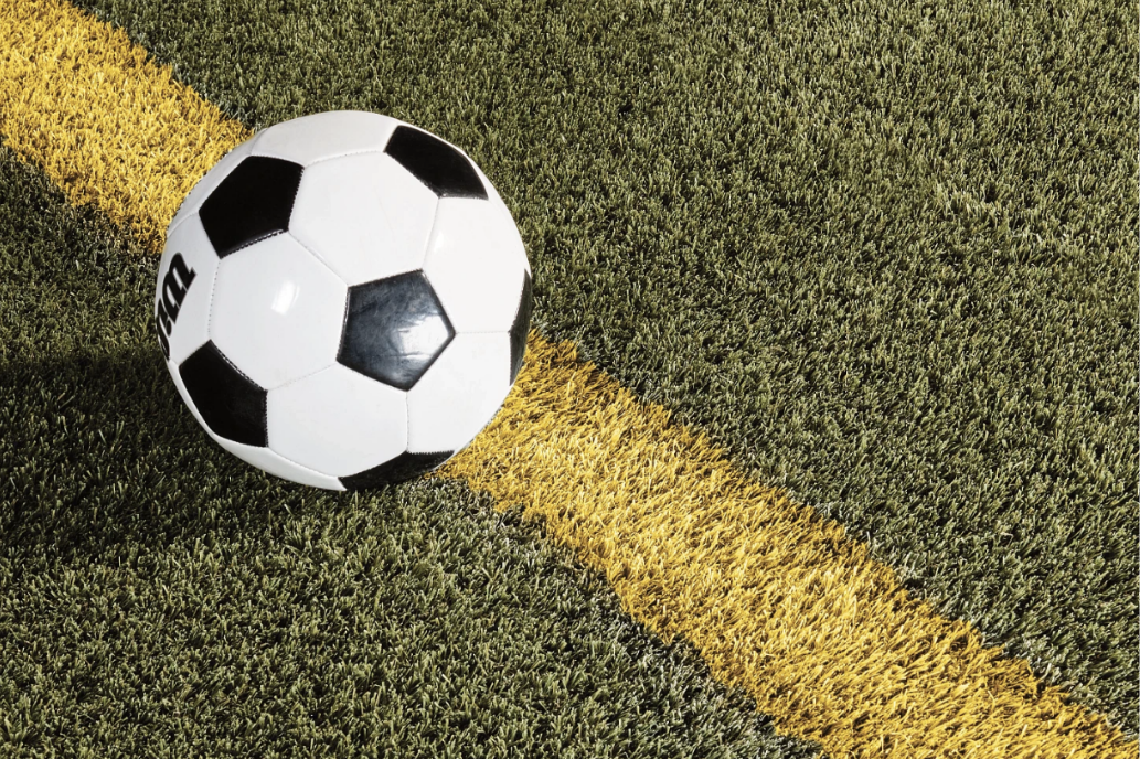 soccer ball and painted line on pitch
