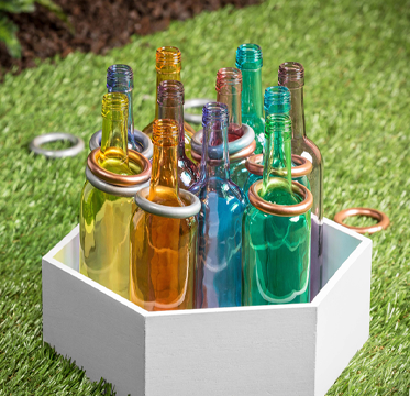 Assortment of glass bottles used in a ring toss game
