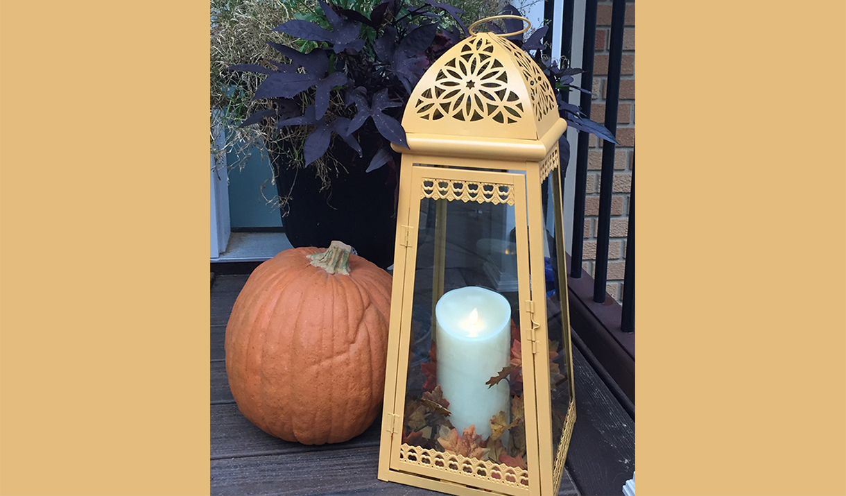 Painted metal lantern and candle