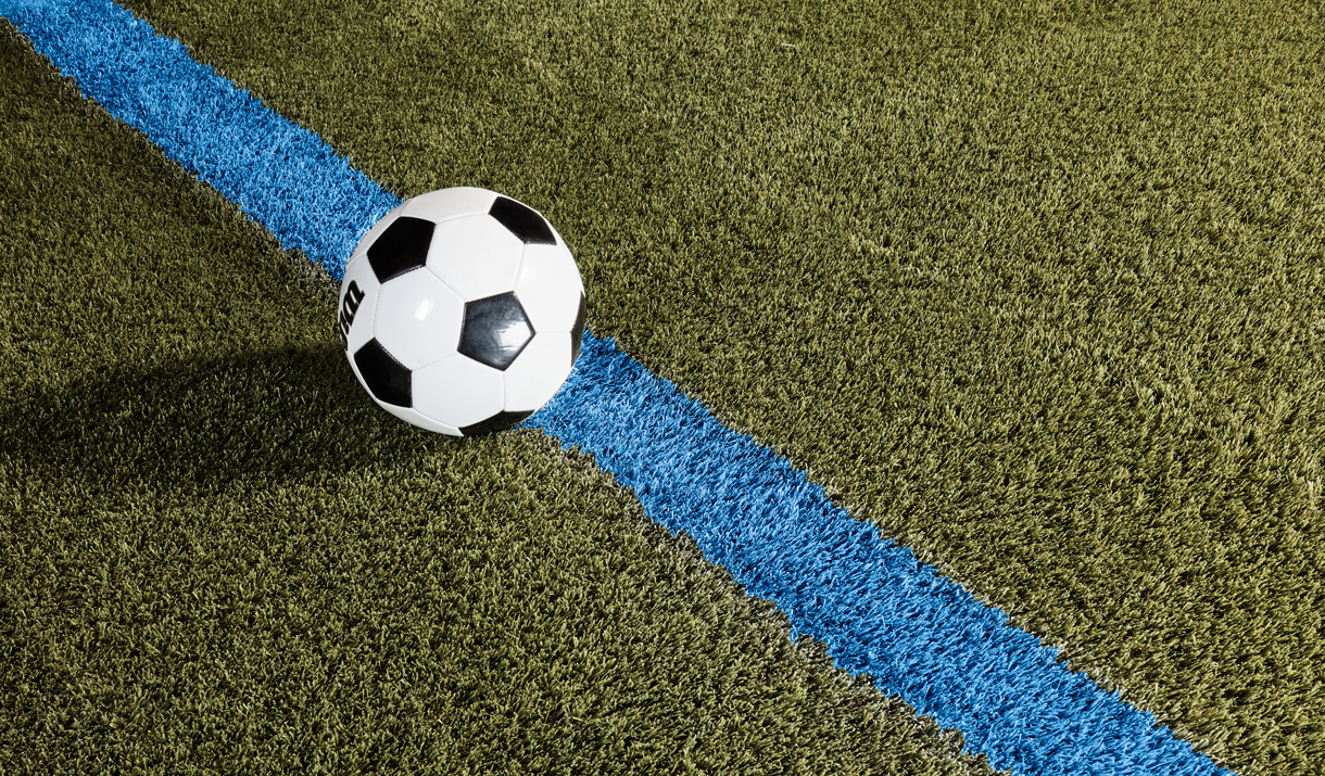 soccer ball and paint stripe on field